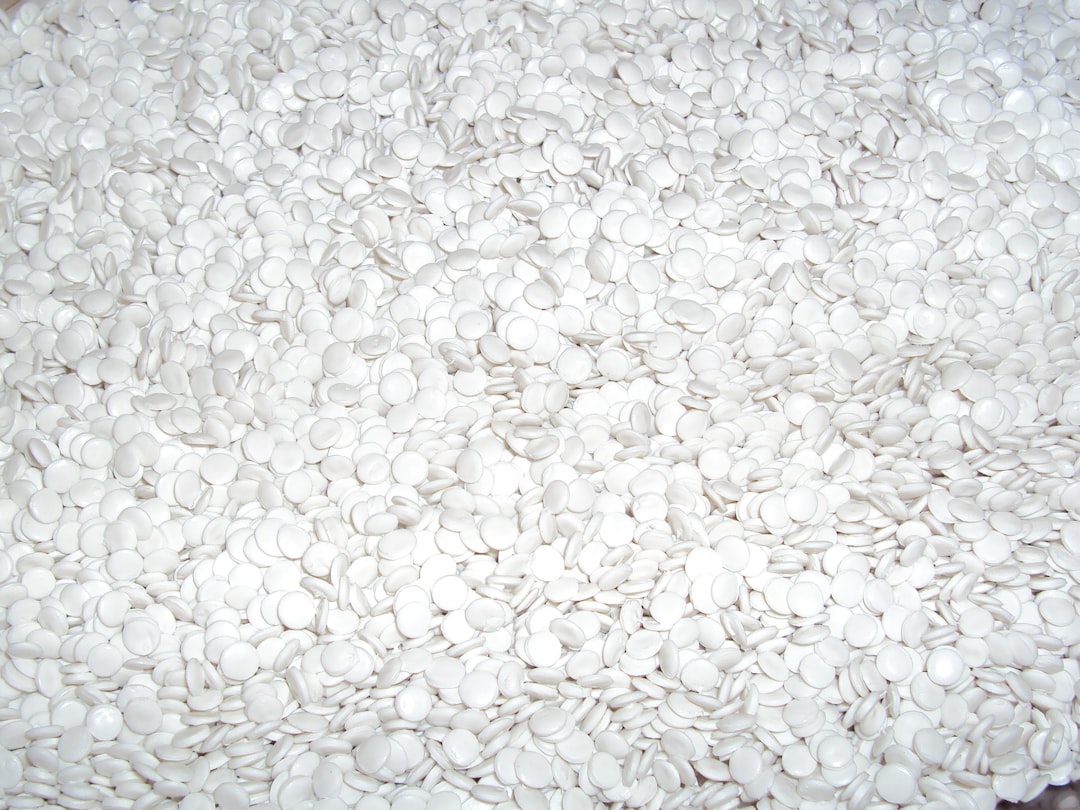 a-close-up-of-a-pile-of-white-buttons-2vbpoas5bc8